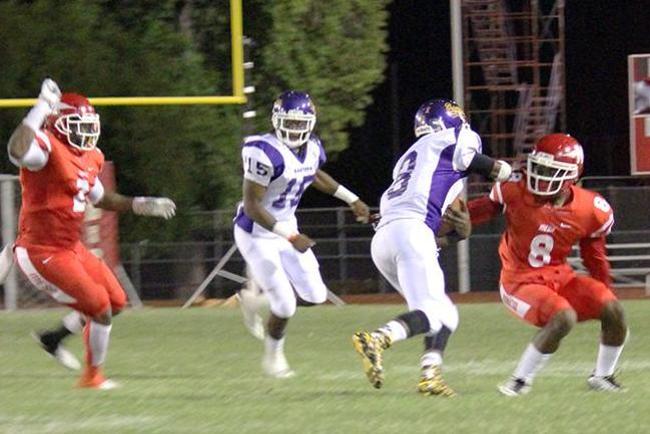 Mesa's Kamon Clayton(#8) attempts to tackle the Eastern Arizona quarterback(photo by Samantha Miller)