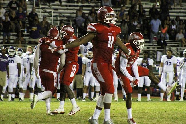 The Mesa defense celebrates after making a momentous 4th quarter goal line stand against Eastern Arizona Saturday night.